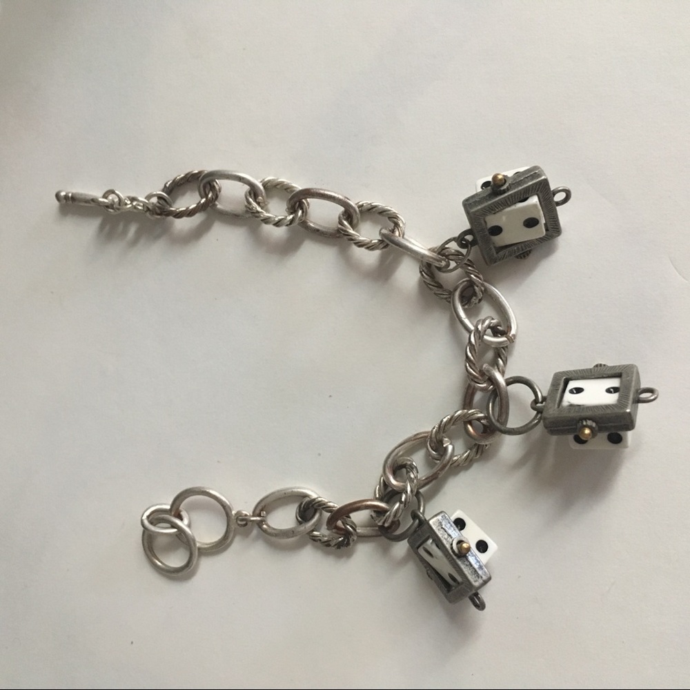Silver charm bracelet.  Three swivel dice.